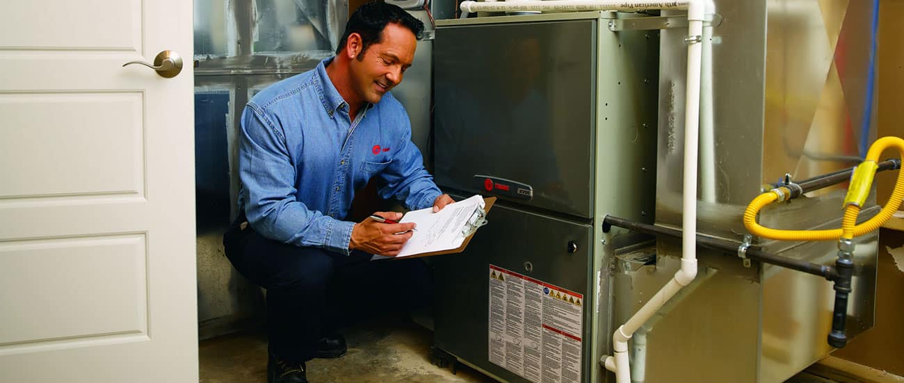 hvac technician checking furnace