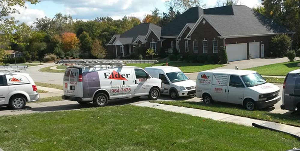 Several Elder Company Vehicles In Front Of House